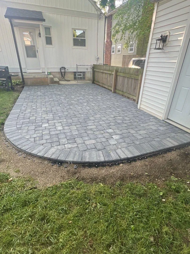 Curved paver patio along a side yard