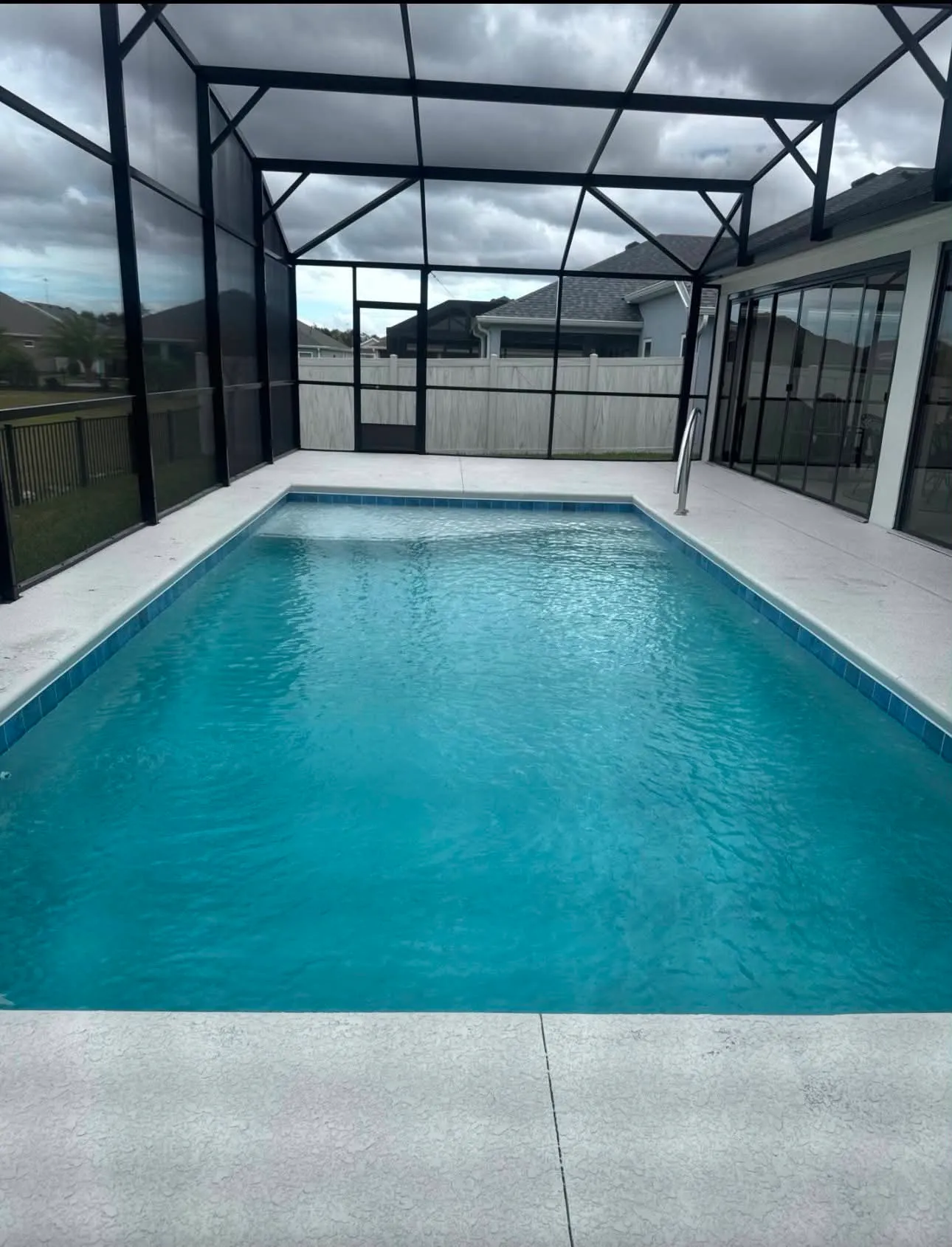 Screened pool enclosure with concrete deck