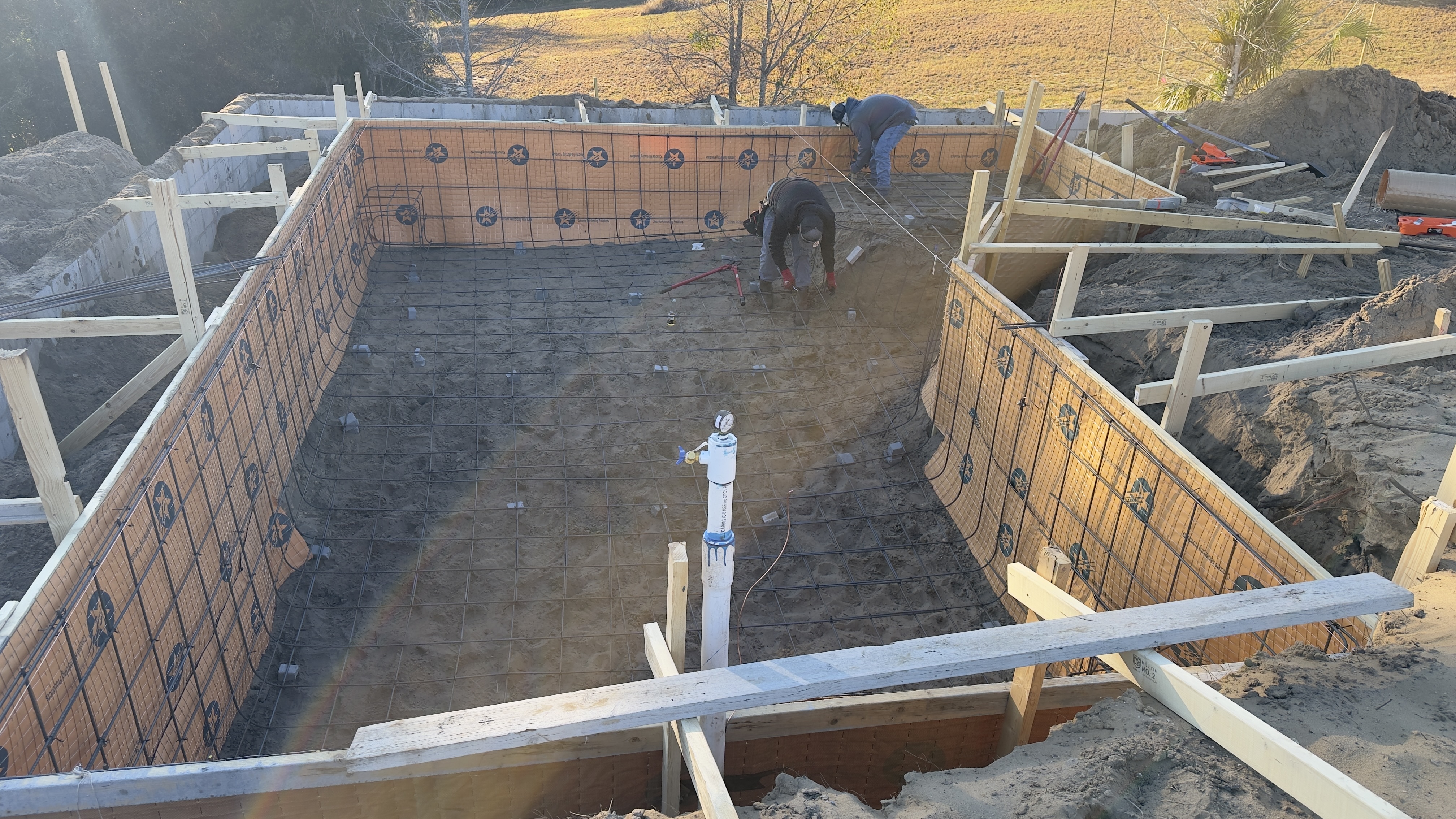ICF wall panels and rebar grid being assembled by the construction crew
