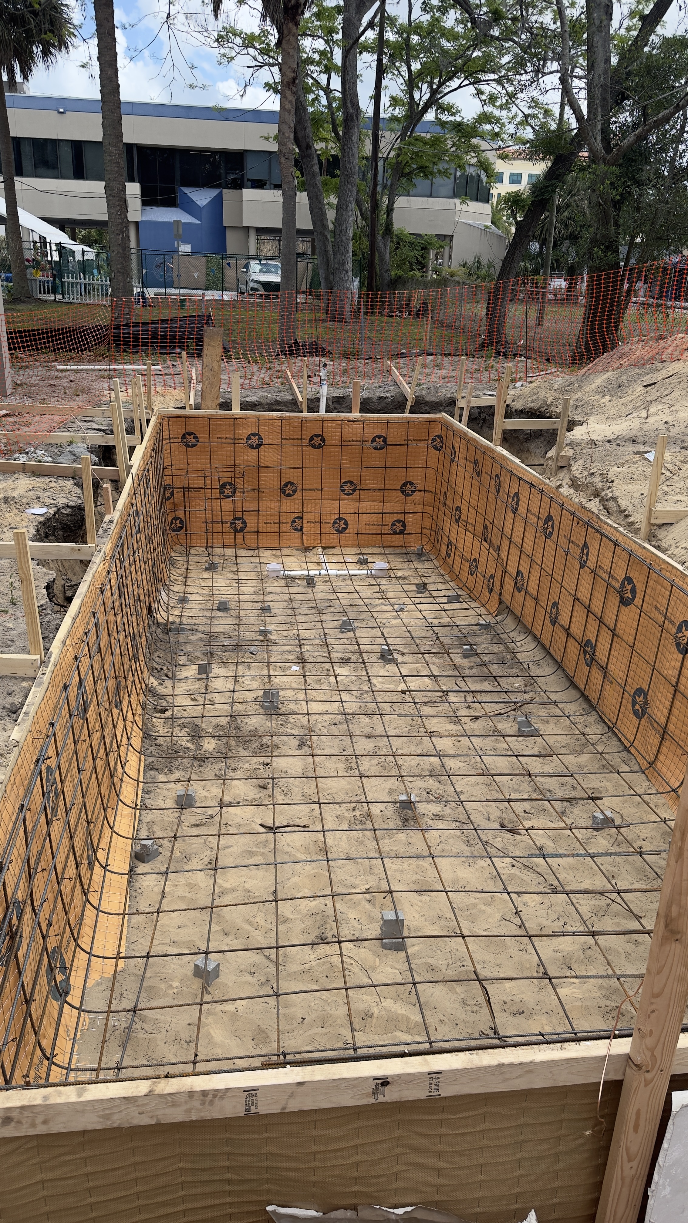 Completed rebar floor mesh with structural walls ready for concrete pour
