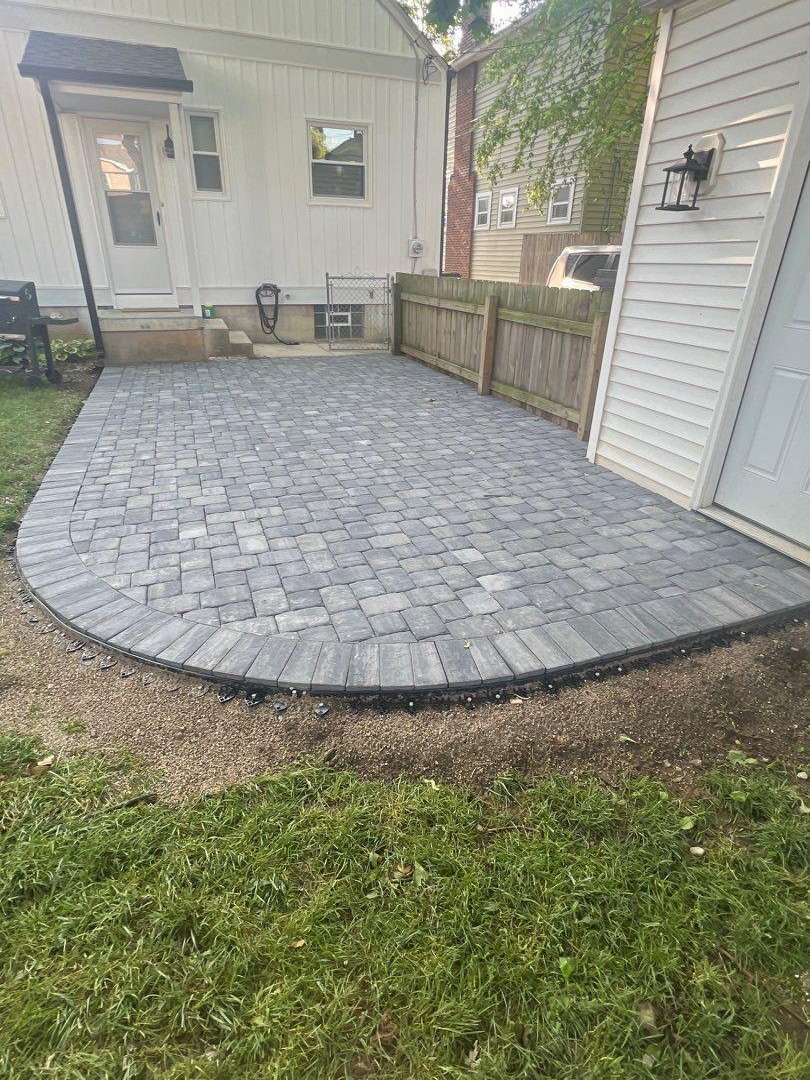 Curved paver patio along a side yard